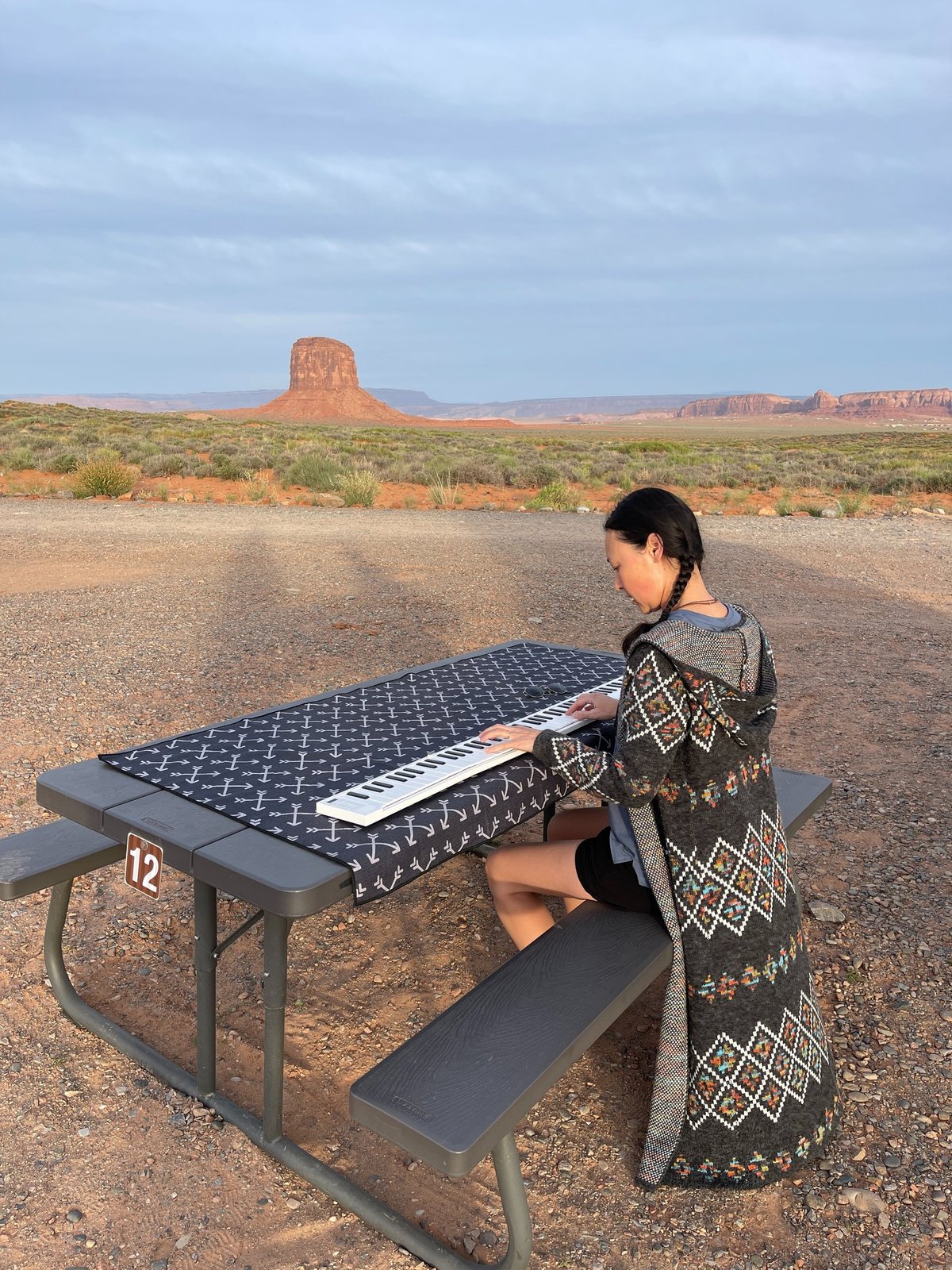 Jen Smith Lanthier playing the keyboard outdoors in Monument Valley